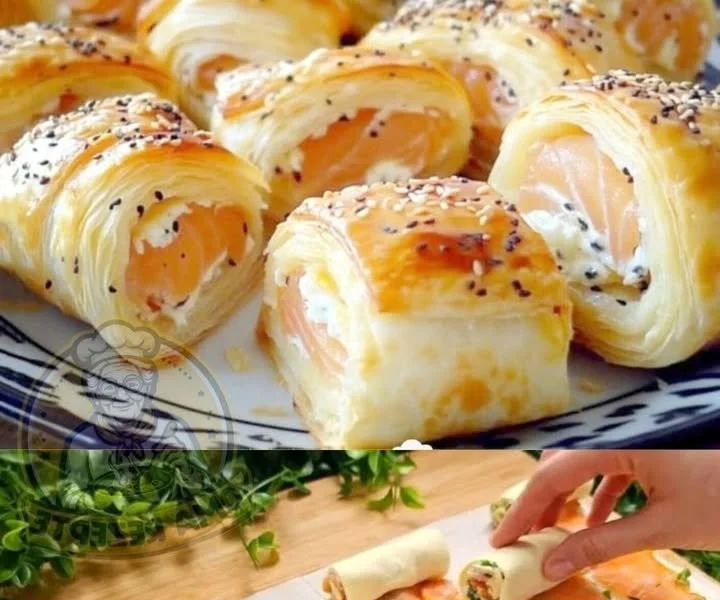 Blätterteig Räucherlachsröllchen frisch serviert auf einem Teller