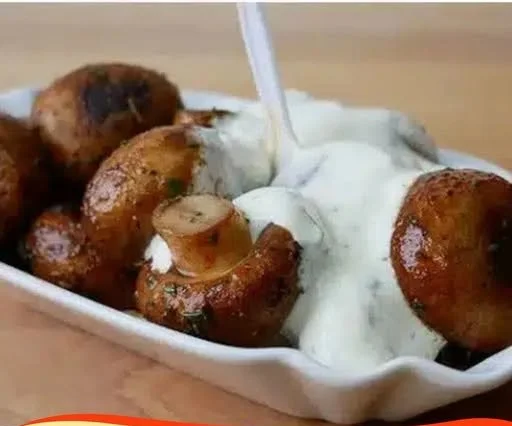 Delicious garlic mushrooms served in a rich sauce, reminiscent of fair food