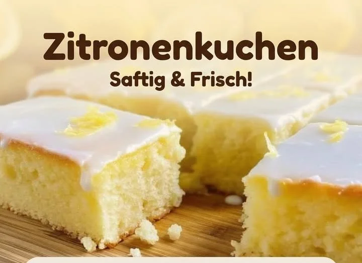 Saftiger Zitronenkuchen auf einem Teller, dekoriert mit Zitronenscheiben.