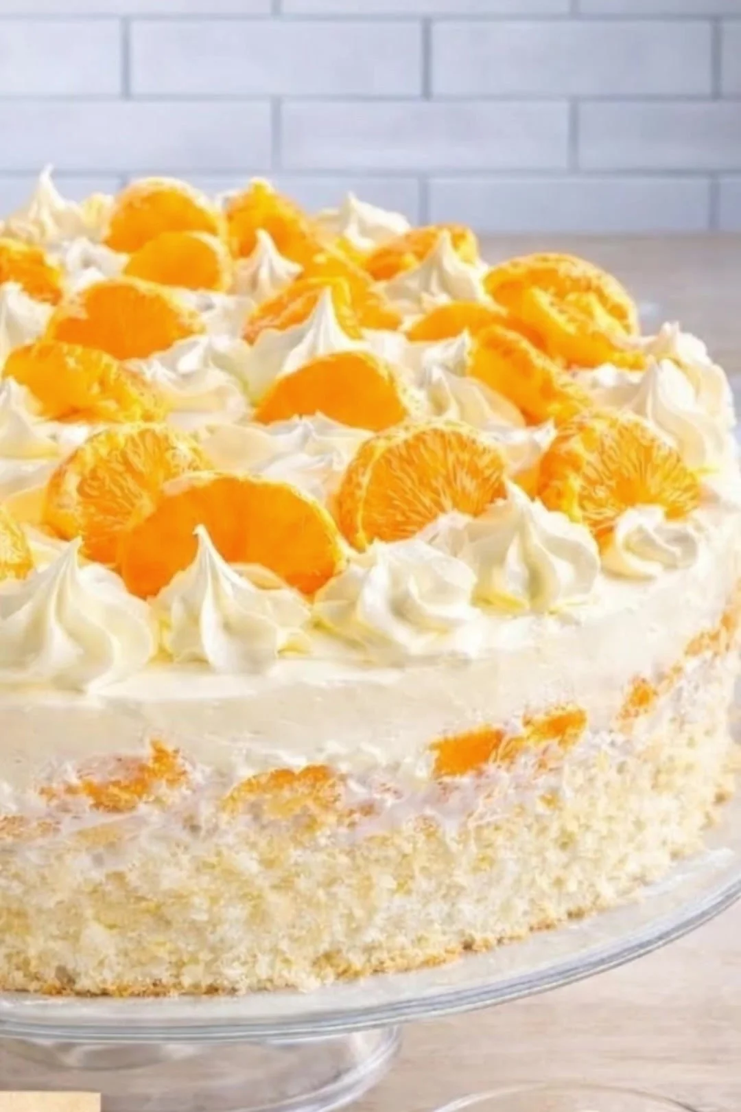 Fantakuchen mit Mandarinen und Vanillecreme auf einem Teller serviert