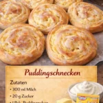 Frisch gebackene Puddingschnecken auf einem Teller dekoriert mit Puderzucker