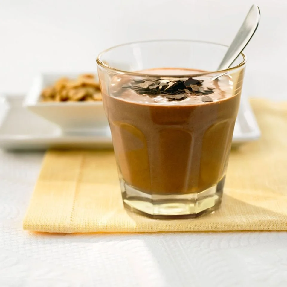 Cremiger Smoothie mit Schokolade und Erdnüssen in einem Glas