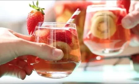 Erfrischende Erdbeer-Sangria in einem Glaskrug mit frischen Erdbeeren und Früchten.