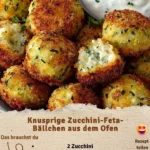 Knusprige Zucchini-Feta-Bällchen frisch aus dem Ofen, serviert auf einem Teller.
