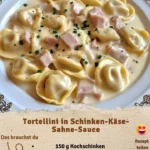 Tortellini in Schinken-Käse-Sahne-Sauce serviert auf einem Teller