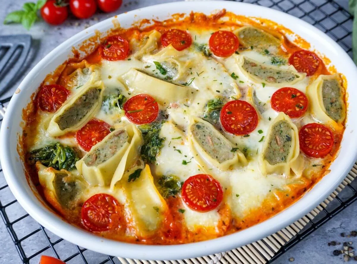 Maultaschen-Auflauf mit Spinat und Tomatensoße in einer Auflaufform
